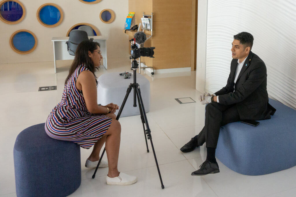 its me interviewing the hotel manager with a camera and a tripod