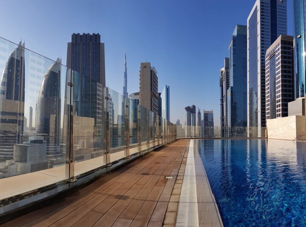 roof top pool surrounded by sky scrappers