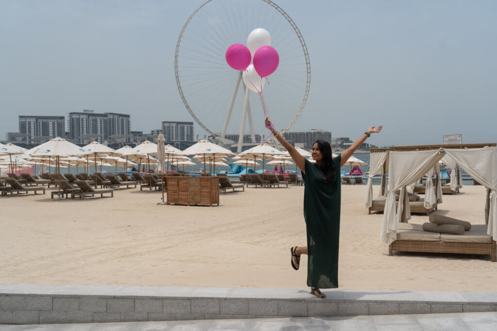 girl at the beach with balloons