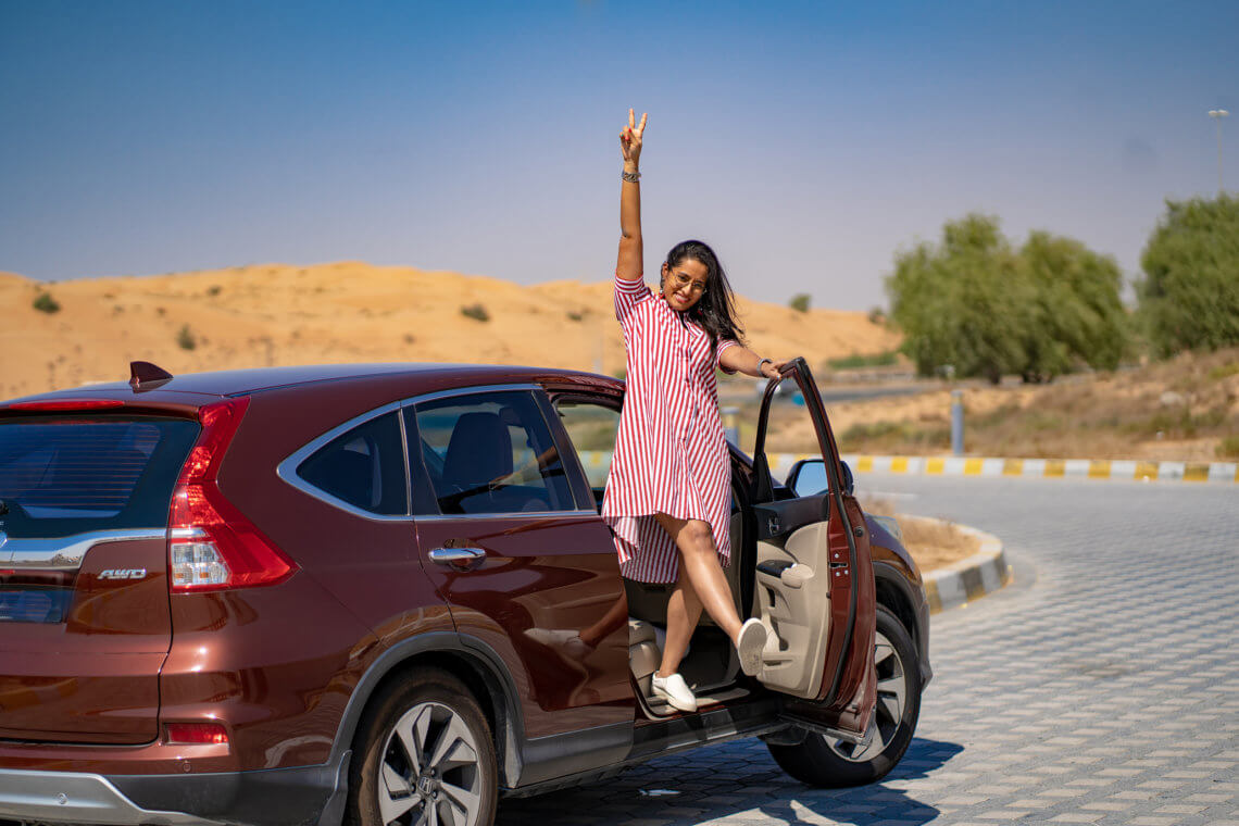 posing with my car on my way to a holiday