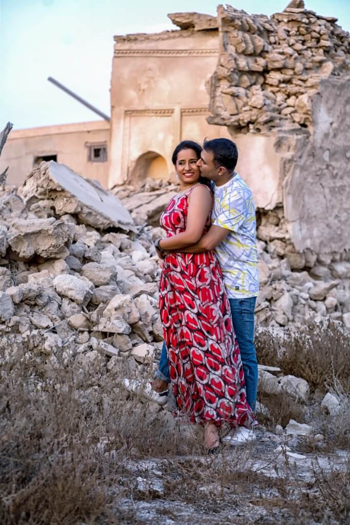 husband and wife posing the ghost village of Ras Al Khaimah