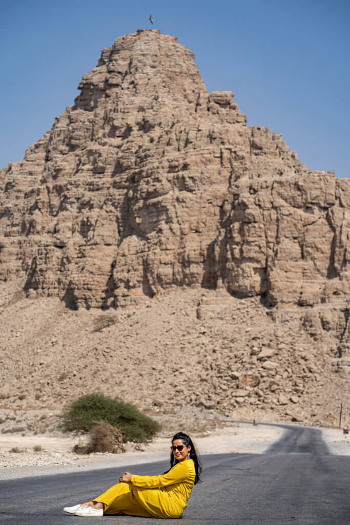 posing near jebel jais mountains on the road